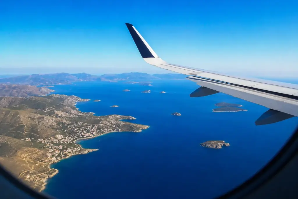 Blick aus dem Flugzeugfenster ueber Mittelmeerkueste und Inseln