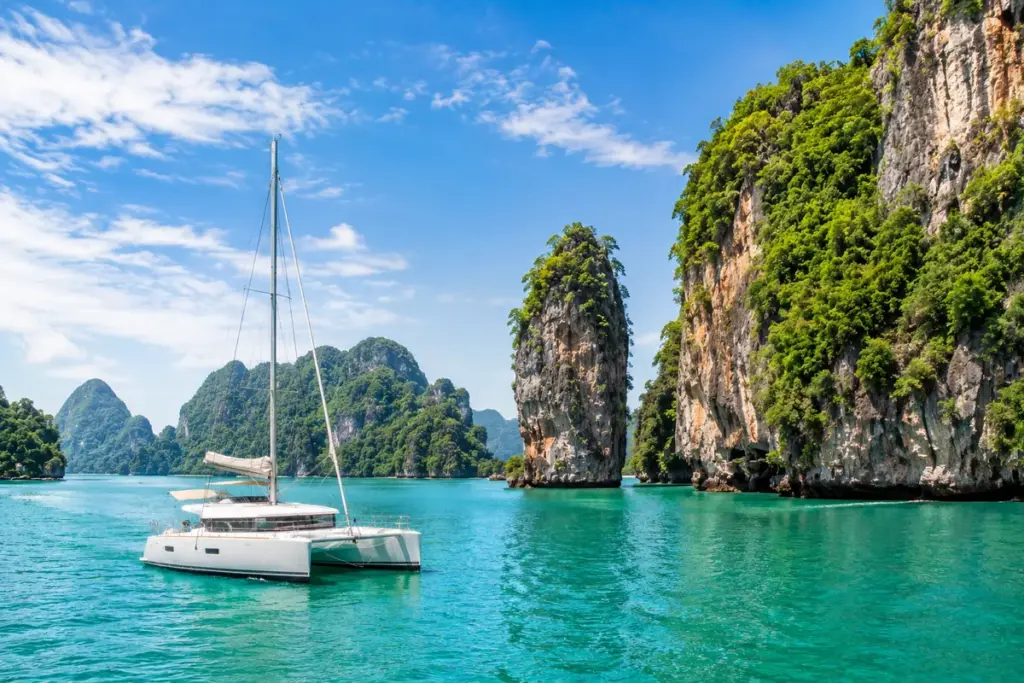 Katamaran zwischen Kalksteinfelsen der Andamanensee bei Phuket in Thailand
